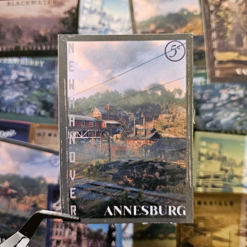 May include: A vintage postcard with a faded image of a small town called Annesburg. The postcard is labeled "New Hanover" and has a 5&cent; stamp in the top right corner.