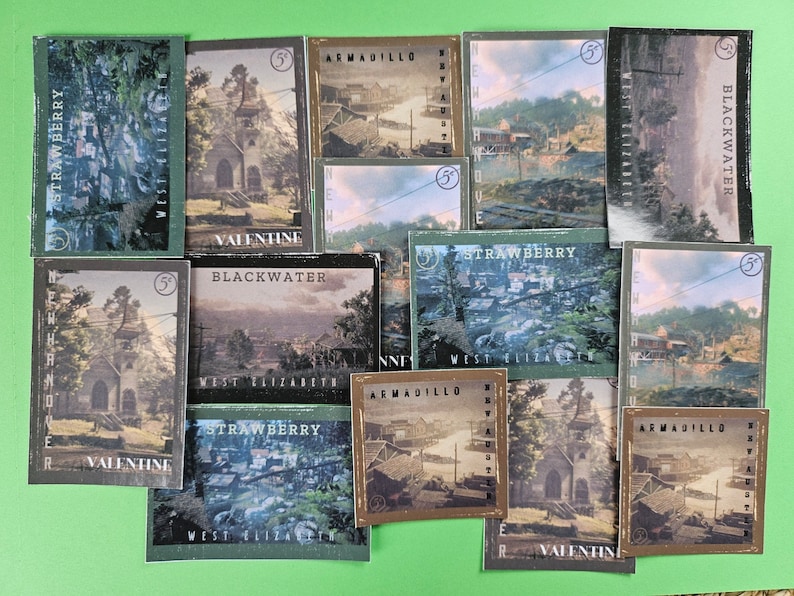 May include: A collection of 10 trading cards featuring various locations from the video game Red Dead Redemption 2. The cards are green, brown, and black with white text. The locations featured include Strawberry, Valentine, Blackwater, Armadillo, and West Elizabeth.