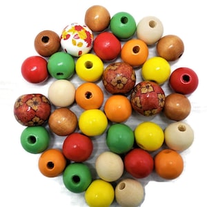May include: A collection of colorful wooden beads in various sizes and colors, including red, green, yellow, orange, and natural wood tones. Some beads feature floral patterns. The beads are round with a hole through the center.
