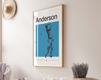 Pode incluir: Uma impressão emoldurada com um fundo azul claro e uma silhueta de um golfista balançando um taco. O texto "Anderson" está impresso em preto no topo da impressão.