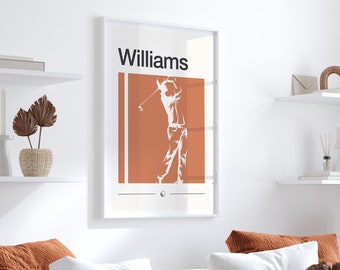 Pode incluir: Um pôster emoldurado branco com o nome "Williams" impresso em preto no topo. O pôster apresenta uma silhueta de um golfista balançando um taco contra um fundo laranja queimado.