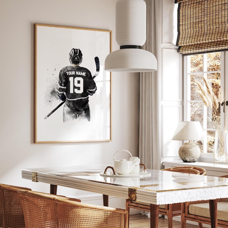 a picture of a hockey player hangs above a dining room table