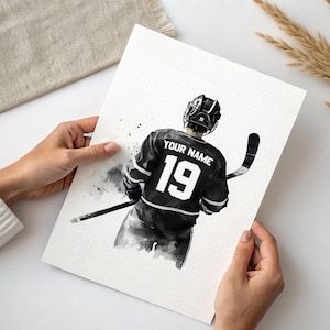 a person holding a card with a picture of a hockey player