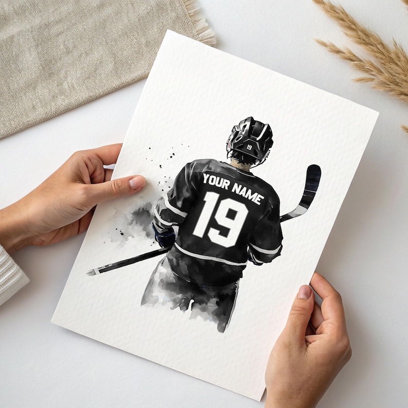 a person holding a card with a picture of a hockey player