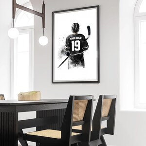 a black and white picture of a hockey player