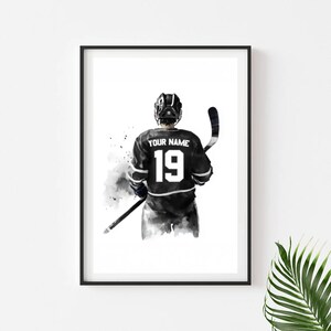 a black and white picture of a hockey player