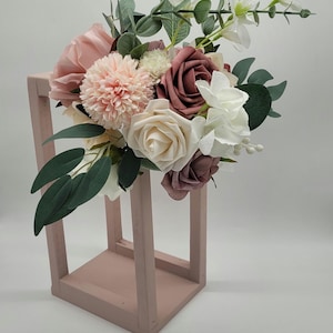 wedding/bridal shower table centerpiece decorations.  Handmade wooden centerpiece topped with flowers.  Light dusty matte pink.