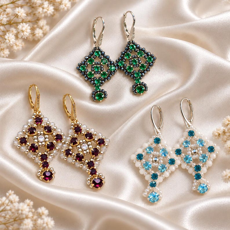 May include: Three pairs of dangle earrings featuring a diamond-shaped beaded frame. One pair has green stones with dark beads, one has deep red stones with white beads, and one has light blue stones with white beads, all with silver-tone lever backs.