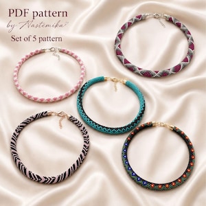 May include: Five circular beaded necklaces featuring distinct geometric patterns in pink, white, magenta, grey, turquoise, black, and multi-colored beads. Each necklace includes a metal clasp and chain. Text reads: PDF pattern by Nastemika Set of 5 pattern.