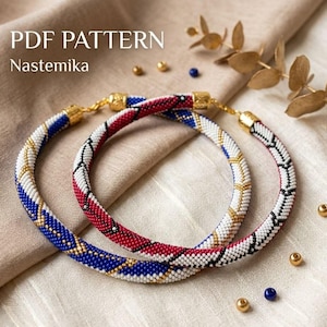 May include: Two beaded necklaces with gold clasps. One necklace is blue and gold, the other is red and white. The text "PDF PATTERN Nastemika" is in the upper left corner. The necklaces are on a beige surface.