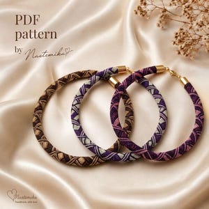May include: Three circular beaded necklaces featuring intricate geometric patterns in shades of brown, purple, and pink. Each necklace has gold-toned metal end caps and a clasp. The text "PDF pattern by Nastemika" is visible in the upper left corner.