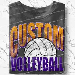May include: Dark gray t-shirt featuring a volleyball design. The shirt has the word "CUSTOM" in orange and purple, with a distressed dot pattern. Below the volleyball is the word "VOLLEYBALL" in purple. The shirt is folded.