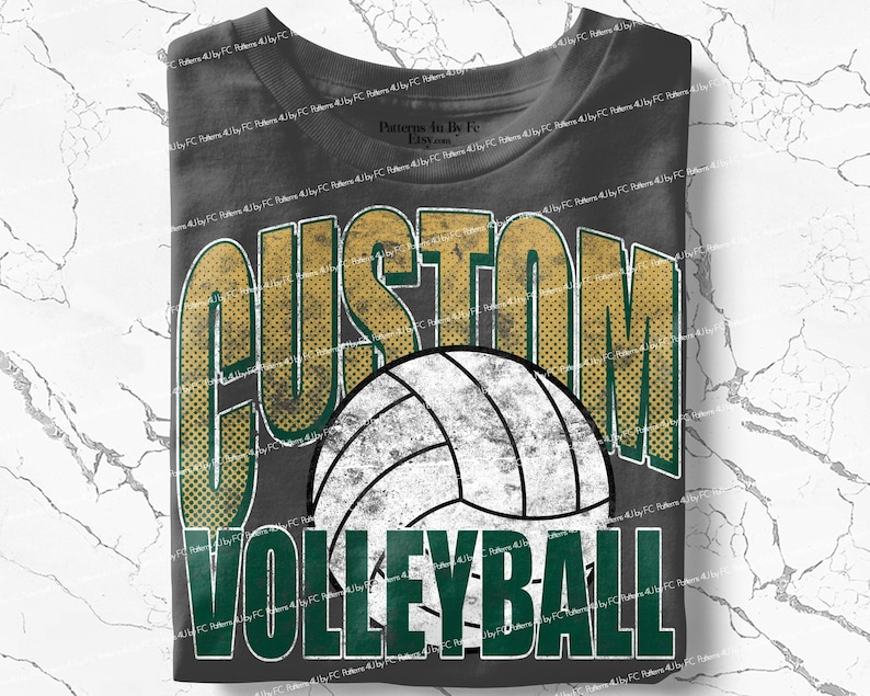 May include: Dark gray t-shirt featuring a volleyball design. The shirt has the word "CUSTOM" in gold and green, with a white and black volleyball graphic. Below the volleyball is the word "VOLLEYBALL" in green.
