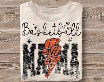May include: White t-shirt with a distressed black graphic that says "Basketball Mama" with a lightning bolt design in orange and black.