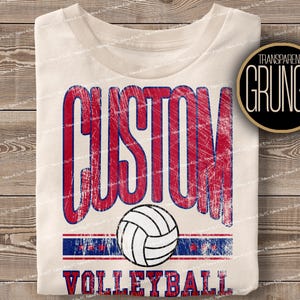 May include: A white t-shirt with a red, white and blue distressed graphic that says "CUSTOM VOLLEYBALL". The graphic includes a volleyball.