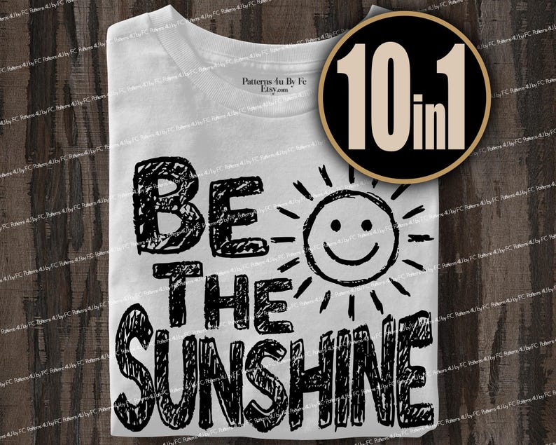 May include: White t-shirt with the phrase "BE THE SUNSHINE" in black, handwritten-style lettering. A smiling sun graphic is next to the text. A circular graphic with "10 in 1" is in the upper right corner.