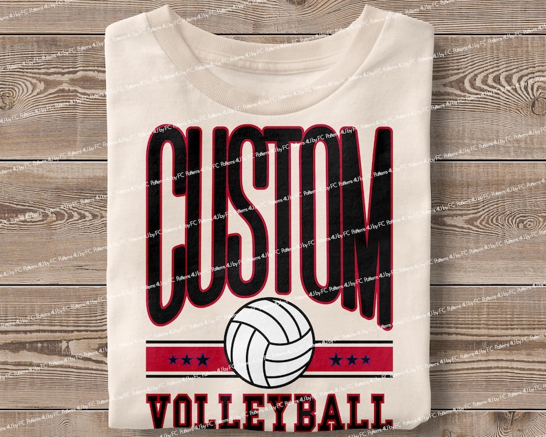 May include: A white t-shirt with the text "CUSTOM VOLLEYBALL" in black and red lettering. A black and white volleyball graphic is centred above the text.