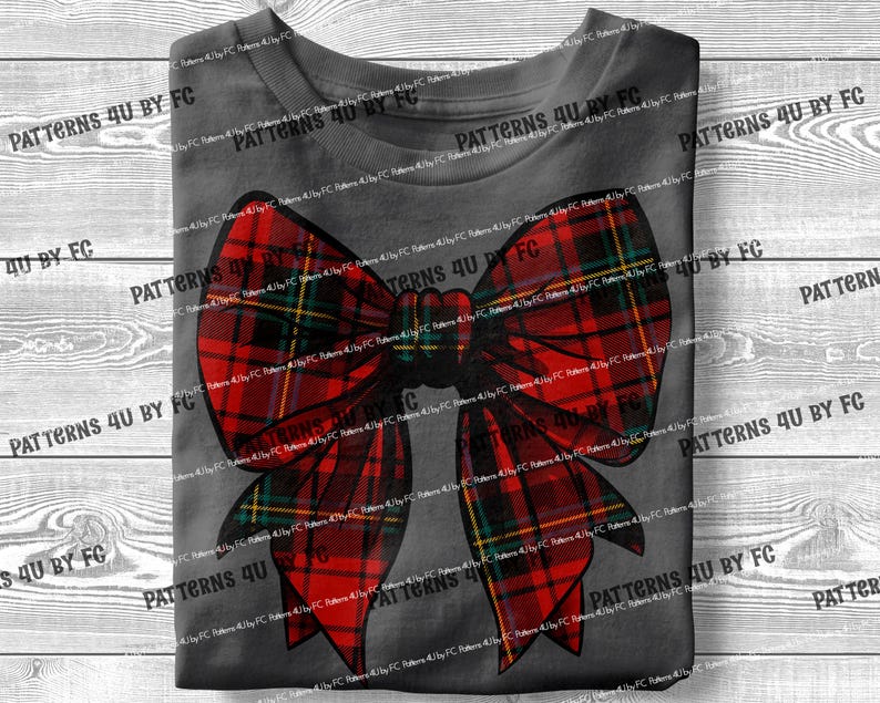 May include: A red and green plaid bow with a yellow and white trim. The bow is on a gray background.