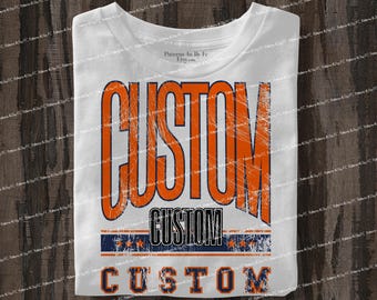 May include: White t-shirt with the word "CUSTOM" in large orange letters. Below the large text is the word "CUSTOM" in black, above a blue and white stripe with stars. The word "CUSTOM" is also at the bottom.