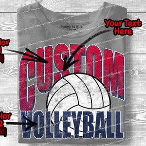 May include: Gray t-shirt with a volleyball design. The word "CUSTOM" is in red, and "VOLLEYBALL" is in navy blue. A white and gray volleyball is in the center of the design. The shirt has a distressed, vintage look.