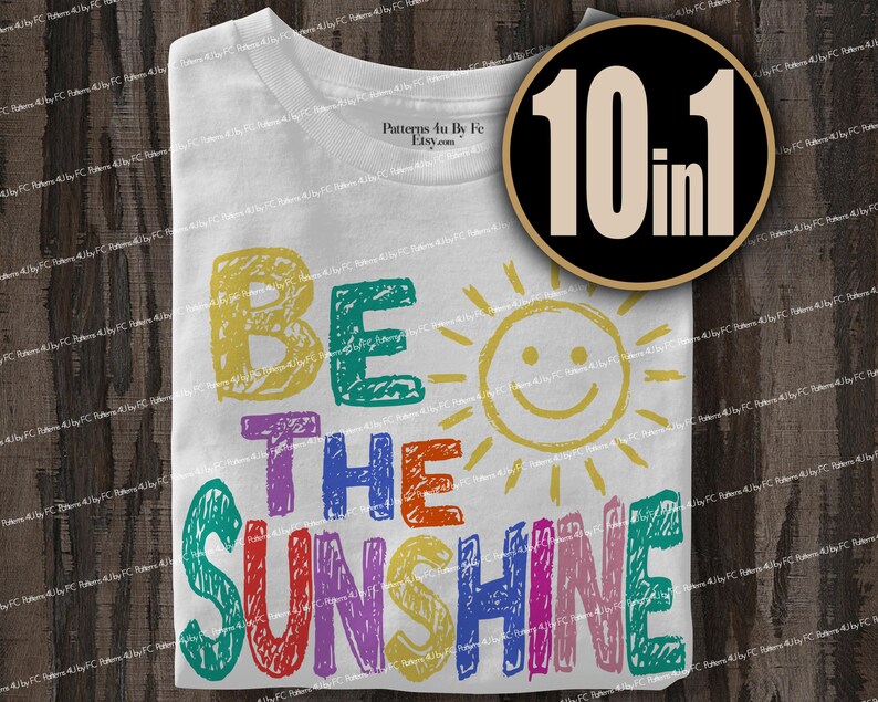 May include: White t-shirt with the phrase "BE THE SUNSHINE" in colorful, hand-drawn letters. A smiling sun graphic is next to the text. A circular graphic with the text "10 in 1" is in the upper right corner.