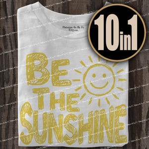 May include: White t-shirt with the text "BE THE SUNSHINE" in yellow, along with a smiling sun graphic. A circular graphic with the text "10 in 1" is in the upper right corner.