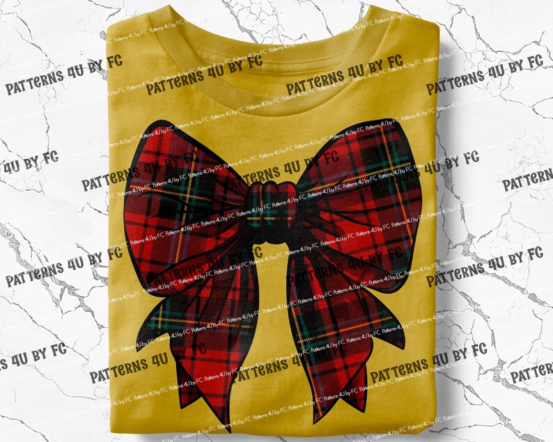 May include: A yellow t-shirt with a large red and black plaid bow on the front. The bow is tied in a knot and has a long, flowing tail.