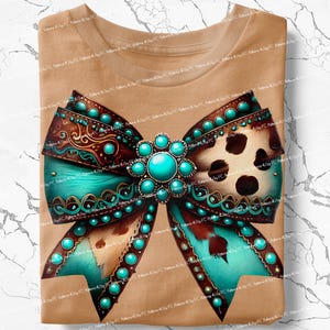 May include: A brown t-shirt featuring a large turquoise and brown bow with a turquoise stone at its centre. The bow has a brown and white animal print design.