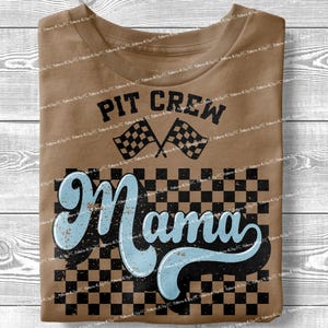 May include: A brown t-shirt with a checkered pattern and the text "Pit Crew Mama" in a blue and black font. The text is stylized with a racing flag design.