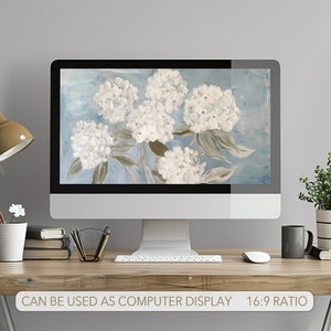 May include: A digital illustration of white hydrangeas on a blue background. The image is displayed on a computer monitor.