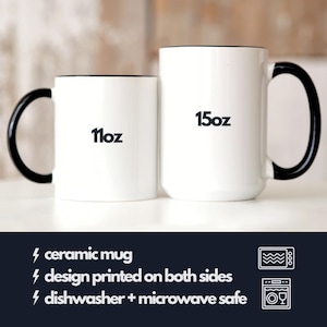 May include: Two white ceramic mugs with black handles and black trim. The smaller mug is 11 oz and the larger mug is 15 oz. Both mugs are dishwasher and microwave safe.
