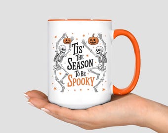 Tis the Season to be Spooky Dancing Skeleton Halloween Coffee Mug: 11oz or 15oz Dishwasher Safe Ceramic Cup with Colored Handle and Interior