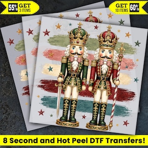 May include: Two nutcracker figures wearing ornate crowns and uniforms in green, red, and gold. One holds a sword, the other a staff. The background features horizontal brushstrokes in muted colors and scattered stars. Text reads 8 Second and Hot Peel DTF Transfers.