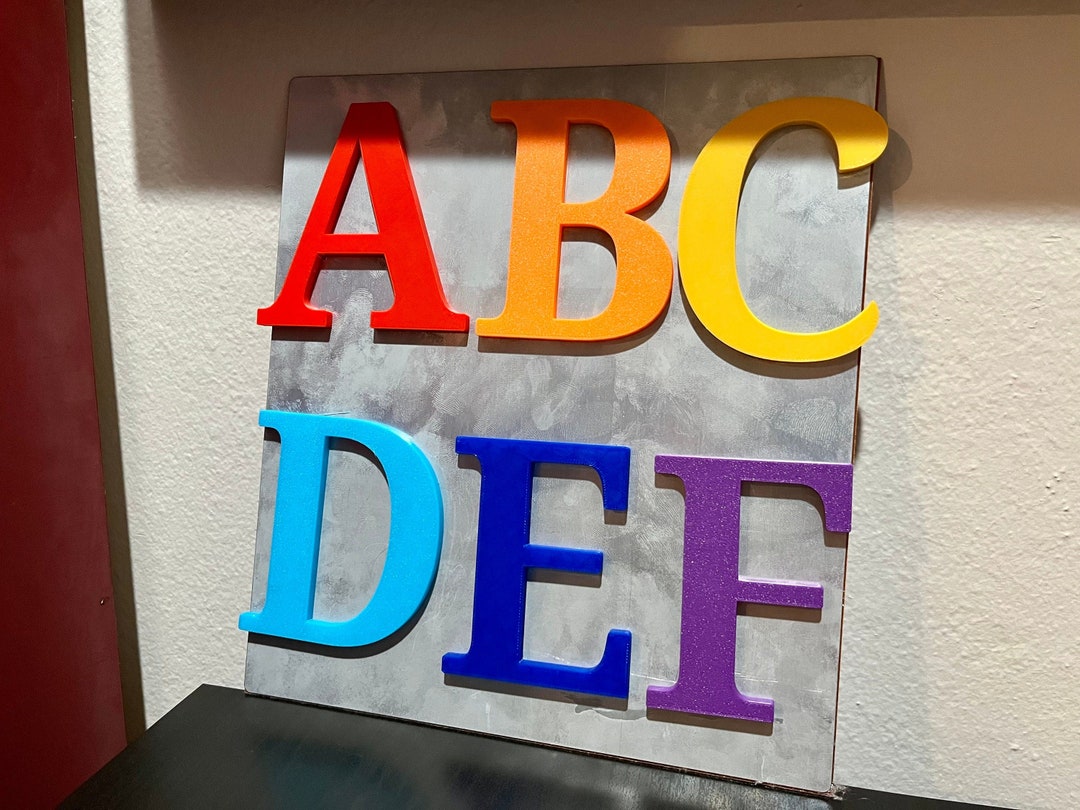 3d Printed Fridge Magnets With Custom Letters and Colors Used to Spell