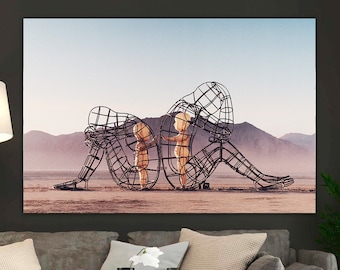 May include: A black and white photograph of three metal sculptures of people in a desert landscape. The sculptures are made of wire and are arranged in a way that suggests a family.