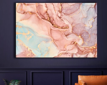 May include: Abstract painting with pink, blue, and gold swirls. The painting is framed and hanging on a dark blue wall.