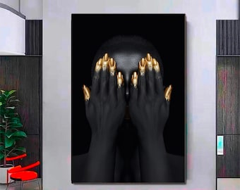 May include: A black and gold abstract portrait of a person with their hands covering their face. The person's hands are painted gold, and their face is obscured by their hands.