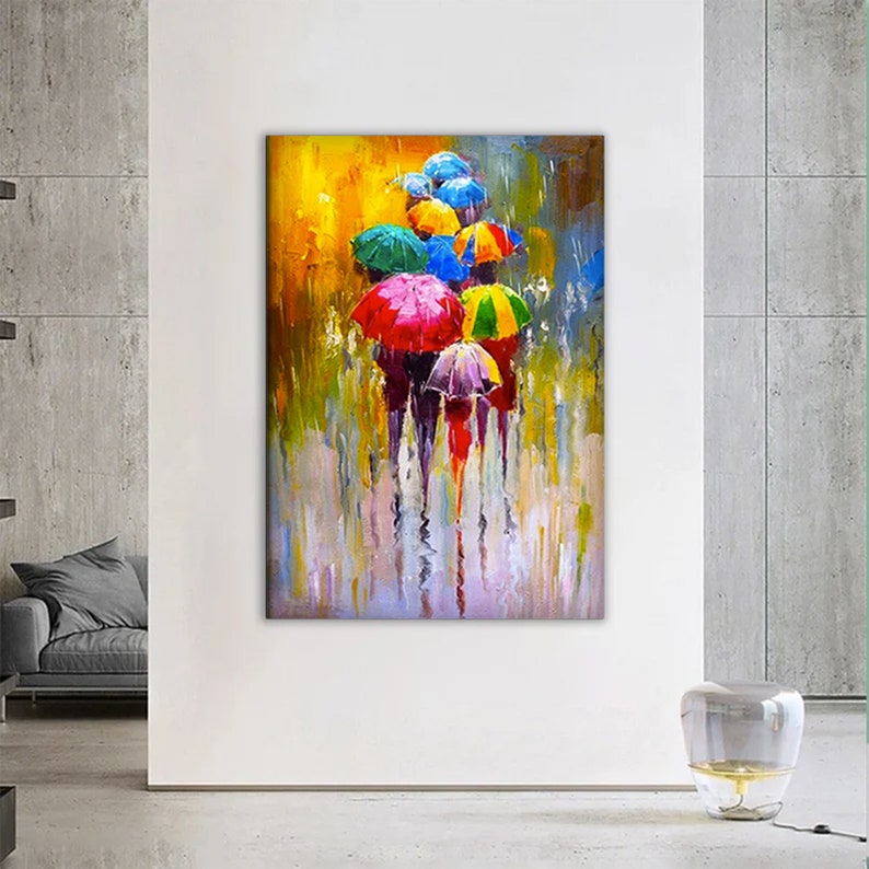 May include: A colorful abstract painting of people walking under umbrellas in the rain. The umbrellas are red, yellow, green, blue, and purple. The background is a blurred yellow and green.