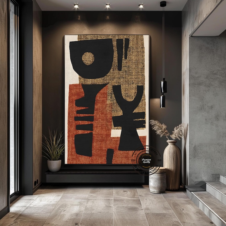 May include: Large abstract canvas art with black, rust, and gold geometric shapes. The artwork features a mix of organic and structured forms, creating a modern and stylish aesthetic. The piece is displayed in a contemporary interior setting.