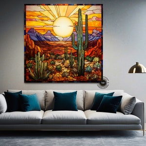 May include: A stained glass artwork depicting a desert landscape with a large saguaro cactus in the foreground. The sun is setting behind the mountains, casting a warm orange glow over the scene.