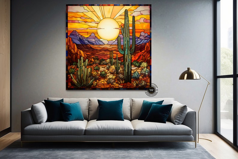 May include: A stained glass artwork depicting a desert landscape with a large saguaro cactus in the foreground. The sun is setting behind the mountains, casting a warm orange glow over the scene.