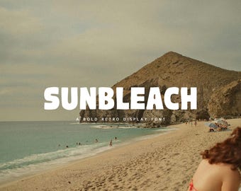May include: The word "SUNBLEACH" in bold white letters dominates the image, with "A BOLD RETRO DISPLAY FONT" below. The scene is a beach with turquoise water, a sandy shore, and a mountain in the background. People are visible on the beach.