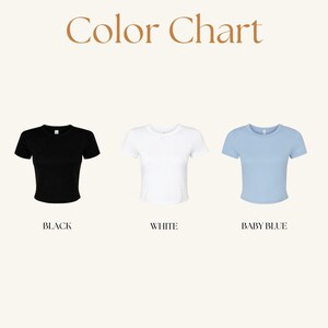 May include: A color chart displays three short-sleeved t-shirts in black, white, and baby blue. The text "Color Chart" is at the top. Each shirt is labeled with its color: "BLACK", "WHITE", and "BABY BLUE".