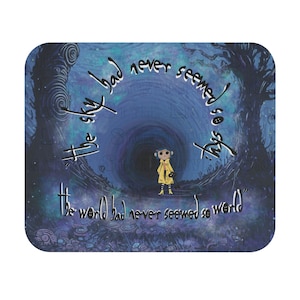 May include: A mouse mat with a design from the film "Coraline." The image depicts a character in a yellow coat in a dark tunnel, with the quote "The sky had never seemed so sky. The world had never seemed so world." in white script.