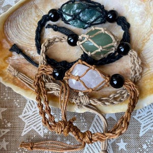 May include: Three bracelets with different colored stones and black beads. The stones are encased in a macrame net. The bracelets are made of brown, black, and natural colored cord.