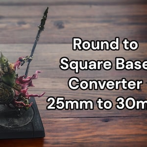 May include: A miniature figure of a warrior holding a spear, standing on a round black base. The figure is painted in shades of green, red, and gold. The text "Round to Square Base Converter 25mm to 30mm" is visible in the image.