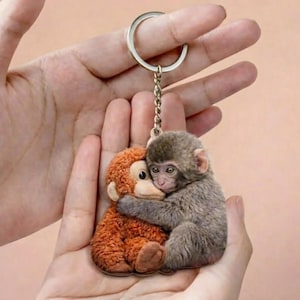 May include: A set of three ceramic mugs with a speckled, matte finish. The mugs are in shades of cream, light gray, and dark gray. Each mug has a simple, minimalist design and a rounded handle.