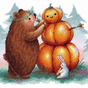 May include: A brown bear wearing a green wreath decorates a stacked pumpkin with a twig for arms. A white rabbit with long ears holds a twig in its paws and stands in front of the pumpkin.