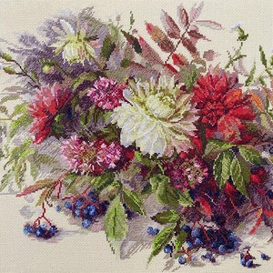 May include: Cross-stitch embroidery depicting a floral arrangement with red, pink, and white flowers, green leaves, and blue berries. The artwork is set against a cream background, showcasing detailed needlework.