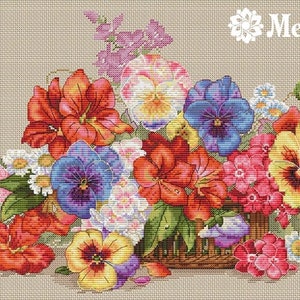 May include: A cross-stitch embroidery design featuring a basket overflowing with colourful flowers, including red, pink, yellow, purple, and blue pansies, daisies, and other blooms. The design is set against a beige background and includes the word "Merejka" in a decorative font.